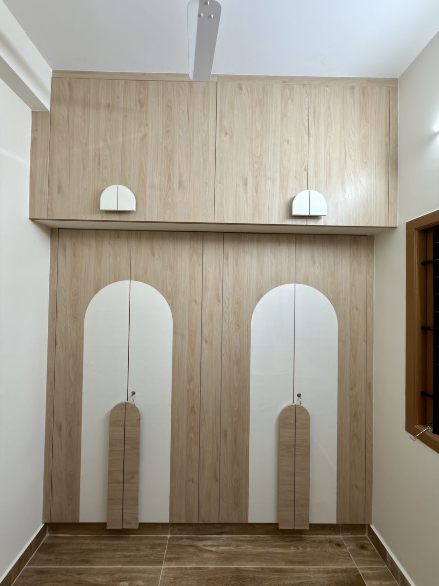 Elegant foyer with arched display niches — residential interior design in Chennai by Dreamcraft Interiors