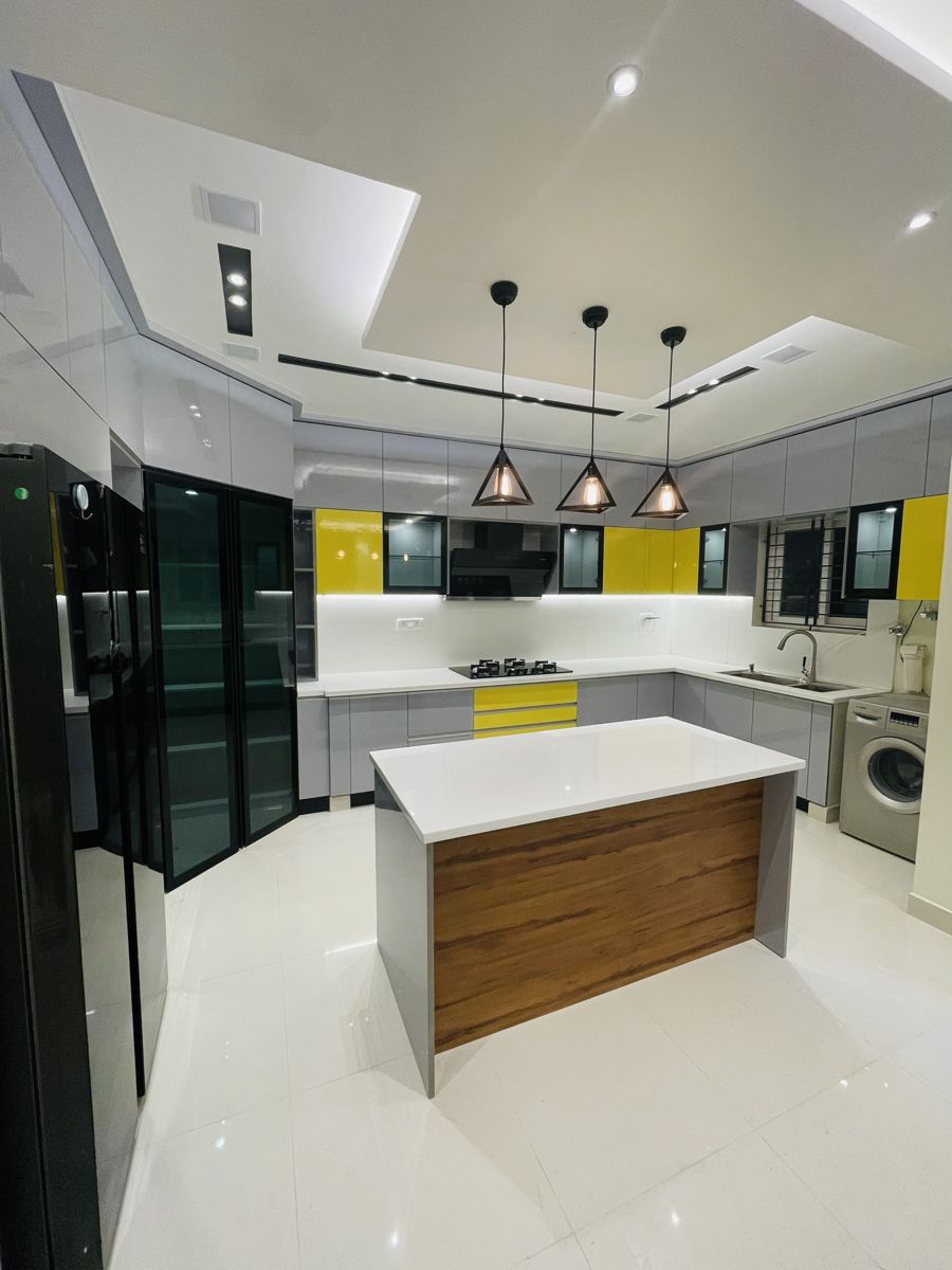 Island modular kitchen with pendant lighting and yellow accents, Chennai handover