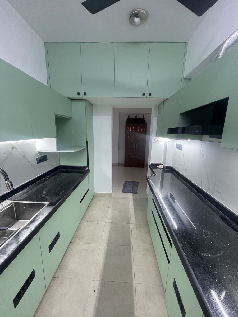Sage green parallel modular kitchen with black countertop, Chennai