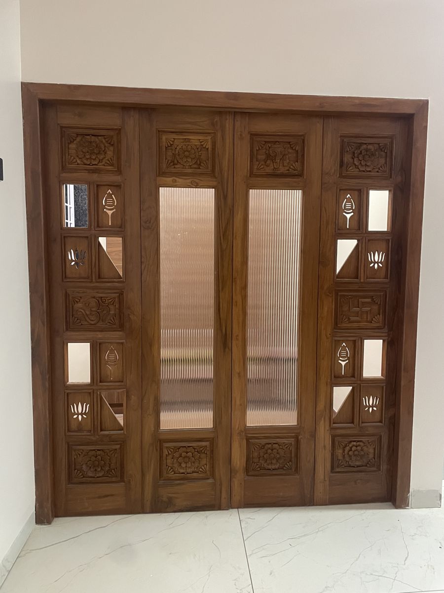 Heritage carved doors as a feature wall in a pooja space, Chennai