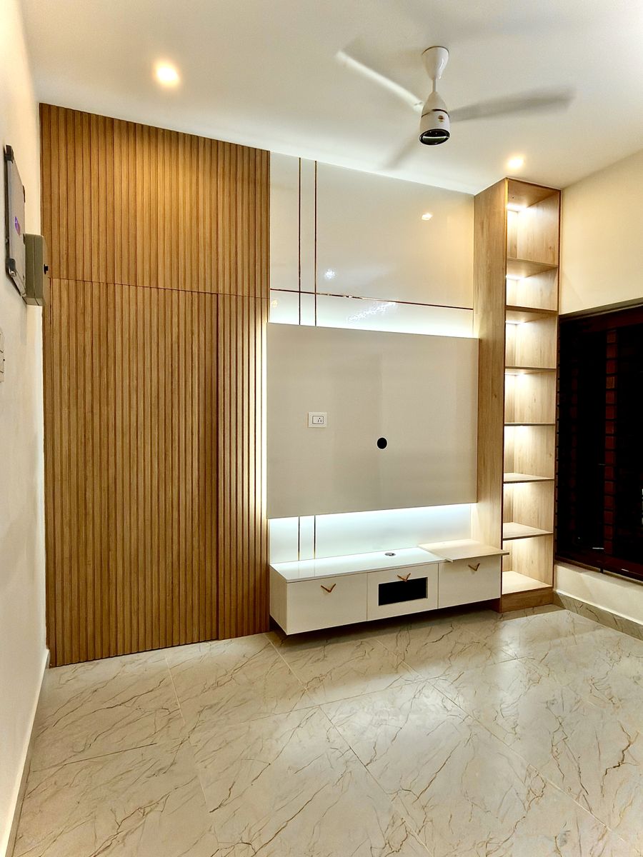 Backlit wooden TV unit in a living room designed by Dreamcraft Interiors, Chennai