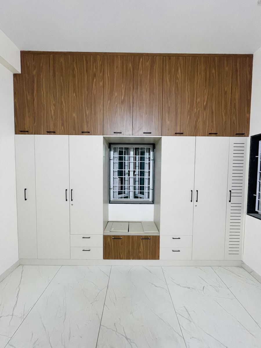 White and wood hinged wardrobe in a bedroom, Chennai