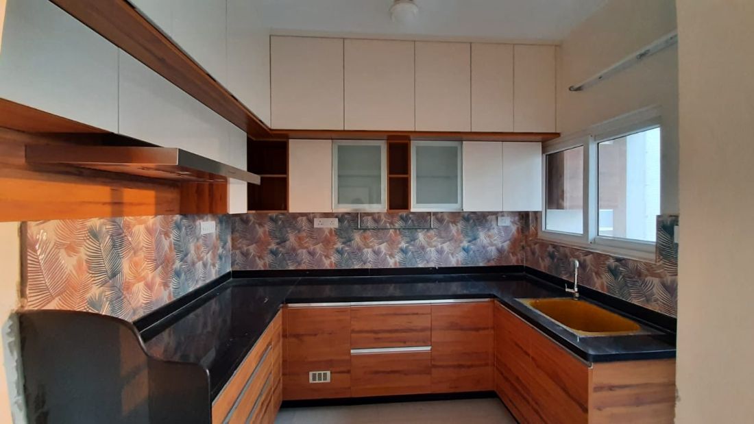 Wood-finish L-shaped kitchen with copper-tone backsplash in Medavakkam, Chennai