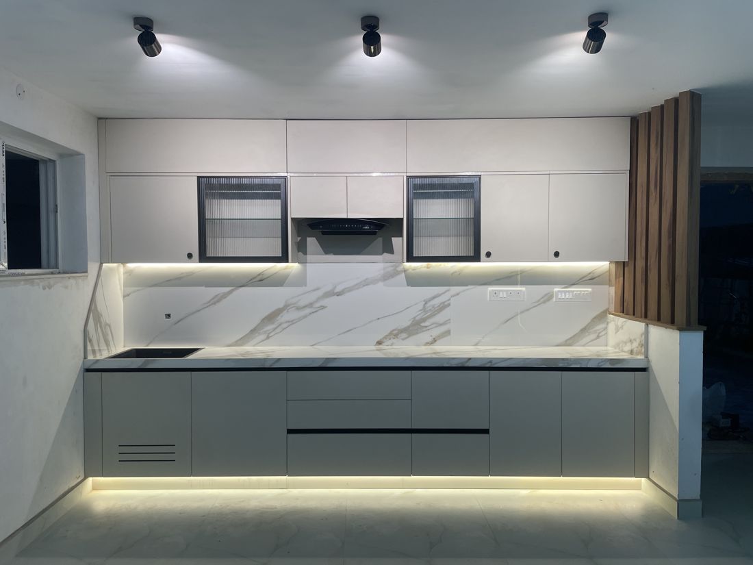Grey kitchen with marble backsplash and backlit counter in Porur, Chennai